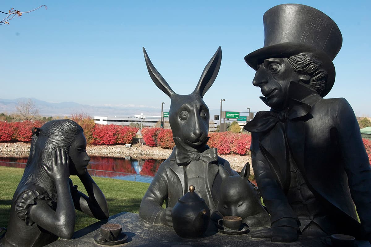 Metal statues of the Mad Hatter, Alice, the rabbit and other characters from Alice in Wonderland at the Museum of Outdoor Arts