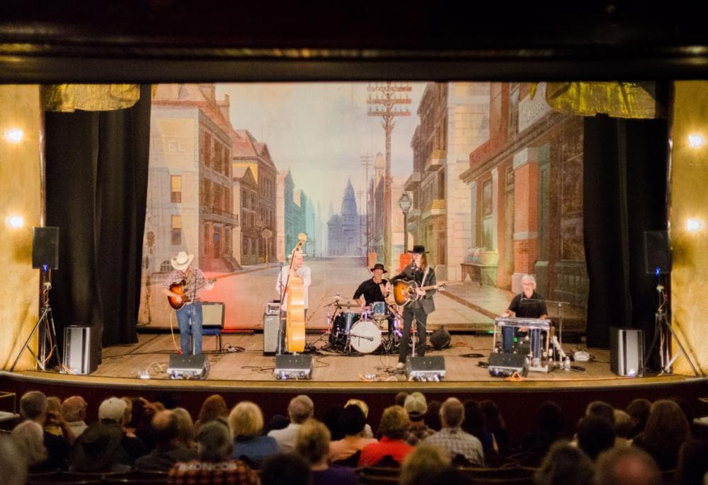 A band in Western wear performs a concert at the historic Tabor Opera House in Leadville