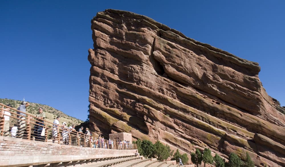 Red Rocks Amphitheatre's towering sandstone rock formations in Morrison, CO on a sunny day with blue skies