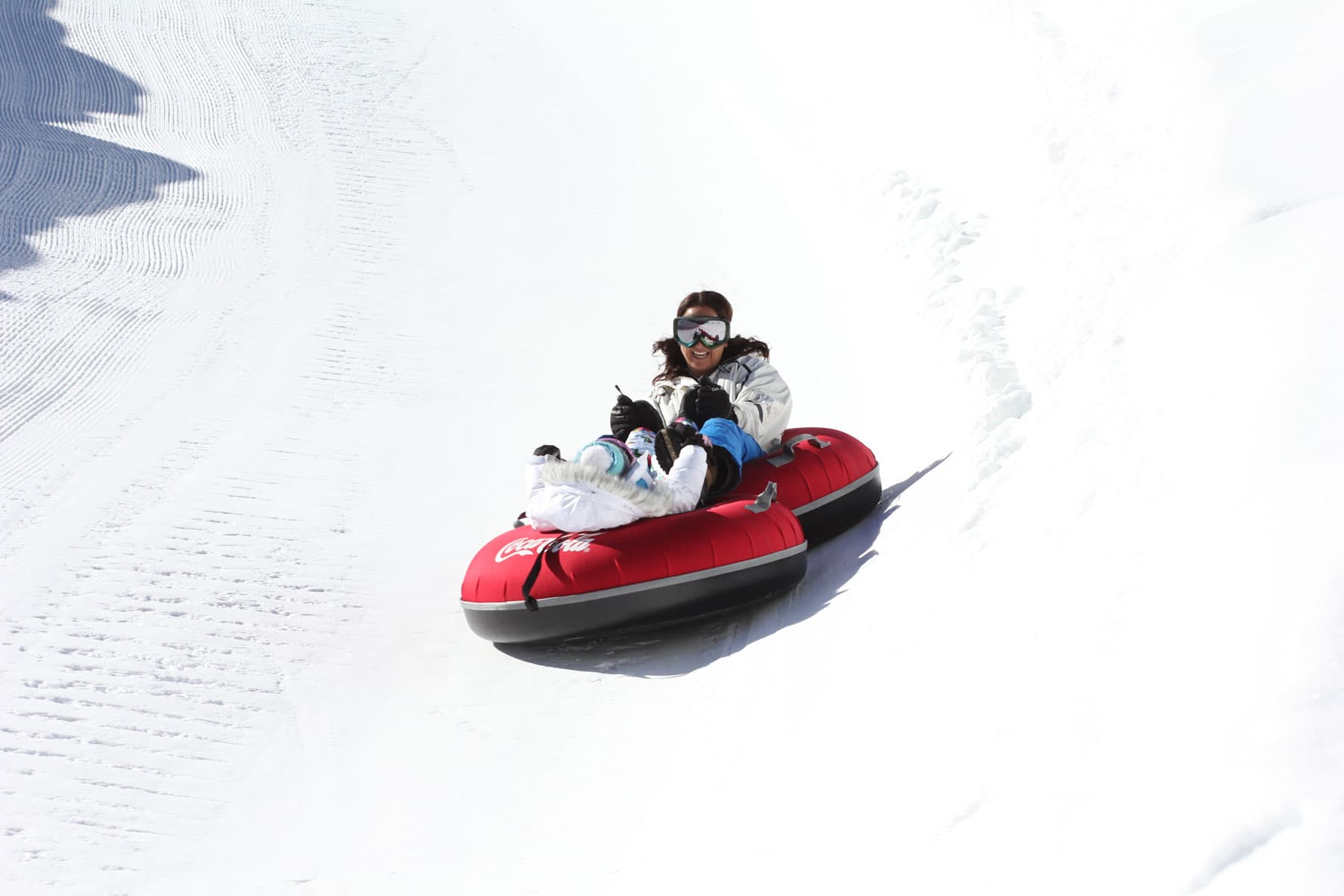 A snow tube races down a snowy mountain