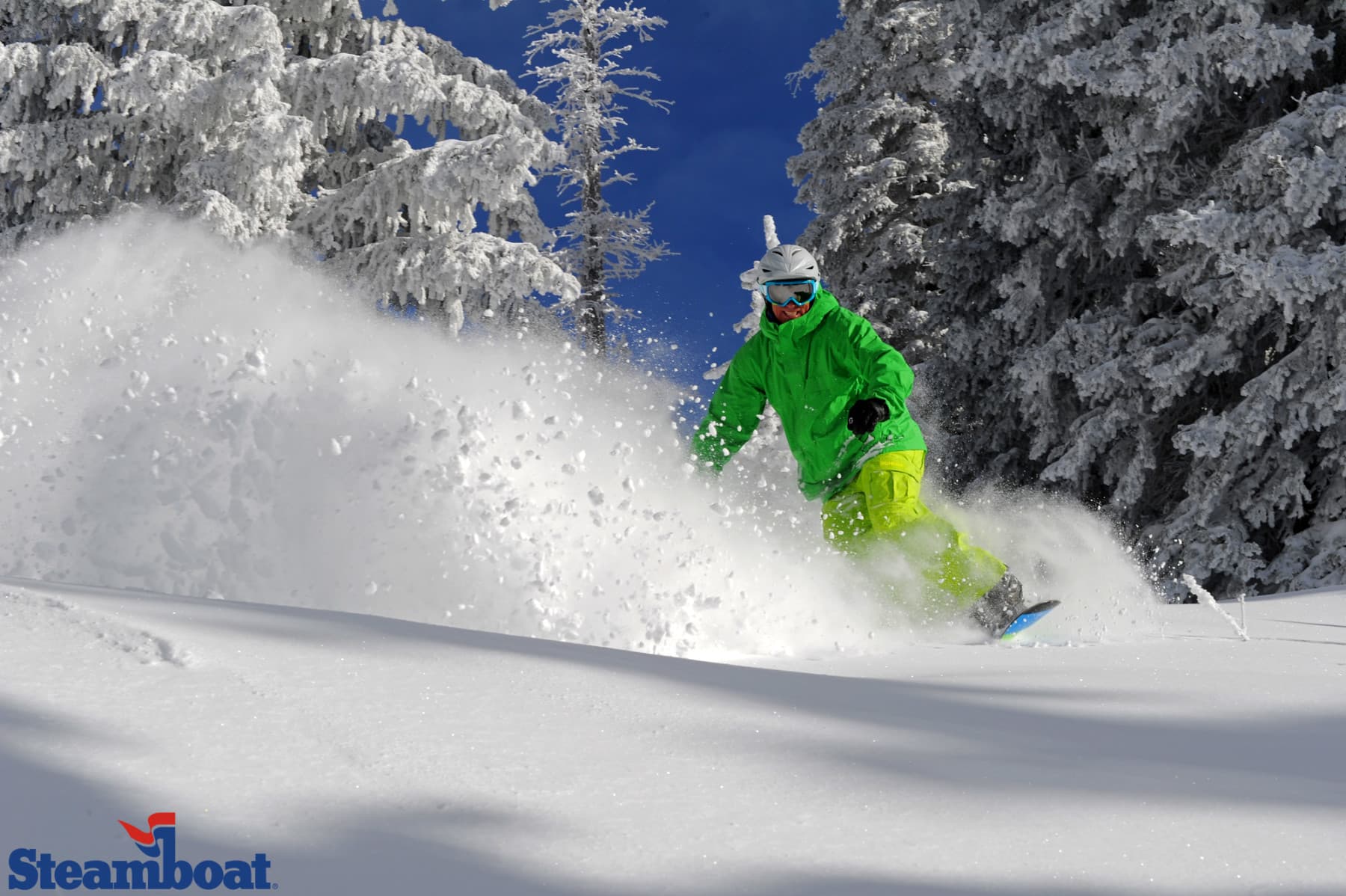a snowboarder slices through steamboat's champagne powder® snow after a storm blanketed the resort overnight. photo